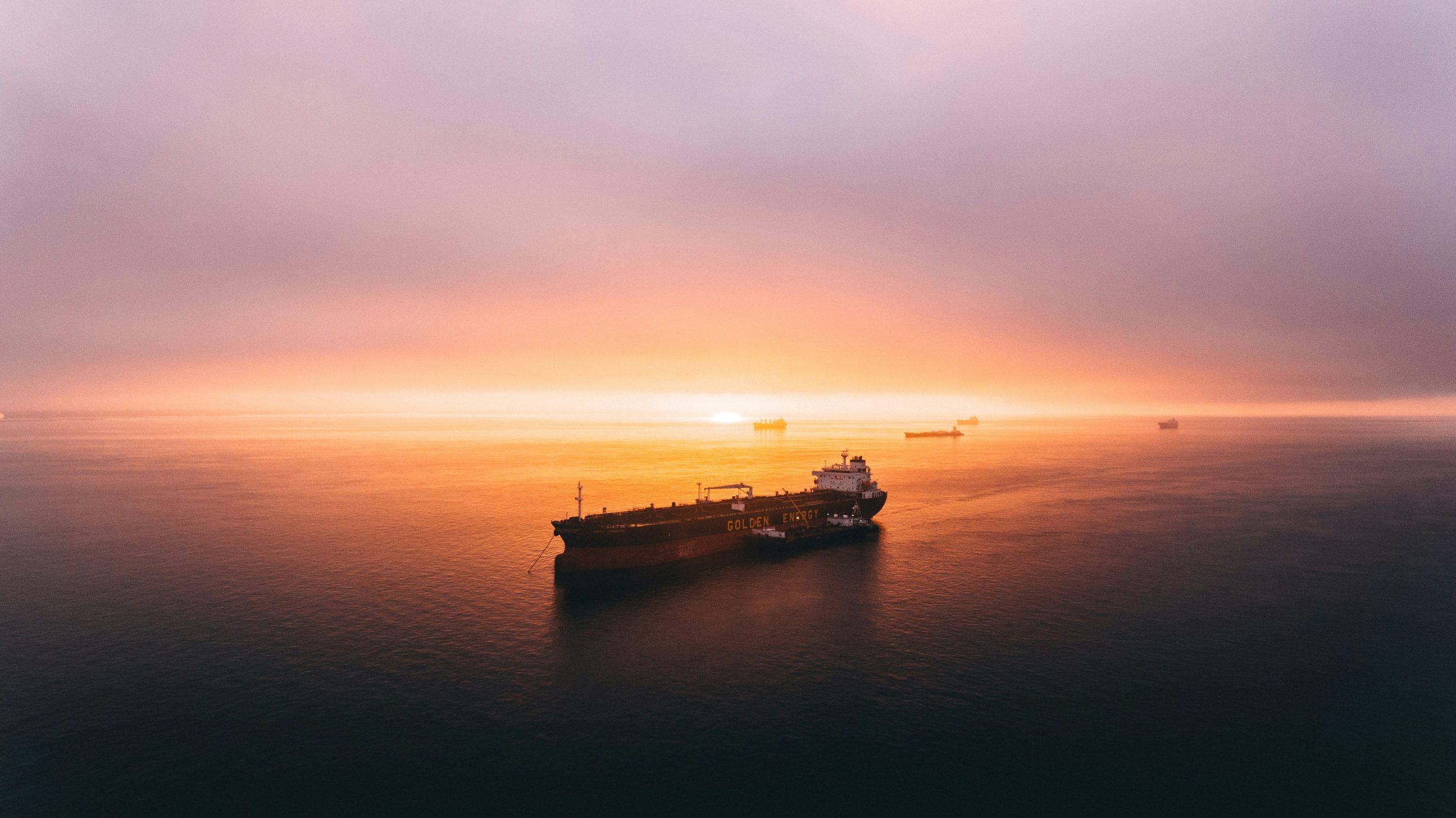 LNG tanker sailing across the sea at sunset.
