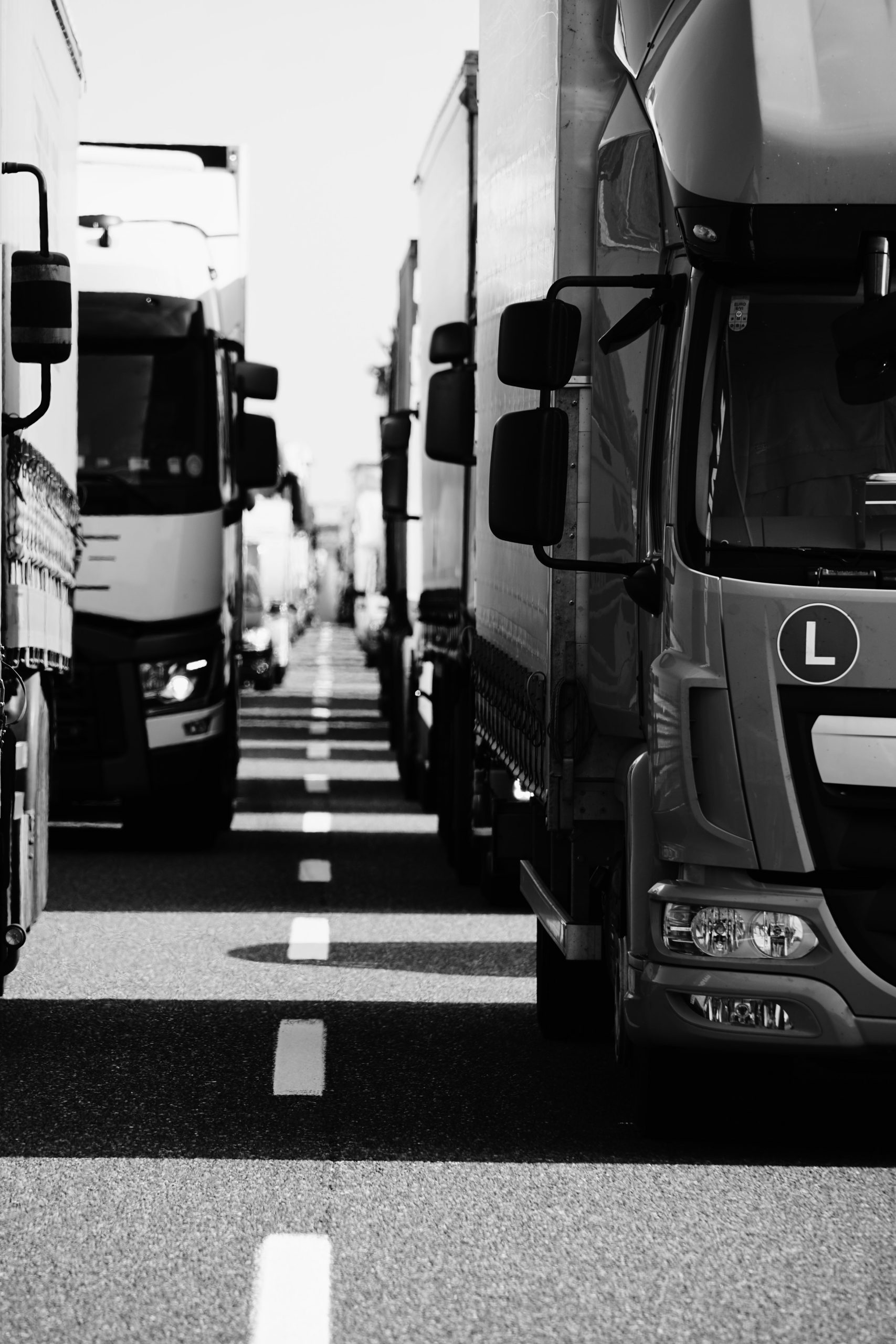 A motorway queued with lorries at either side.