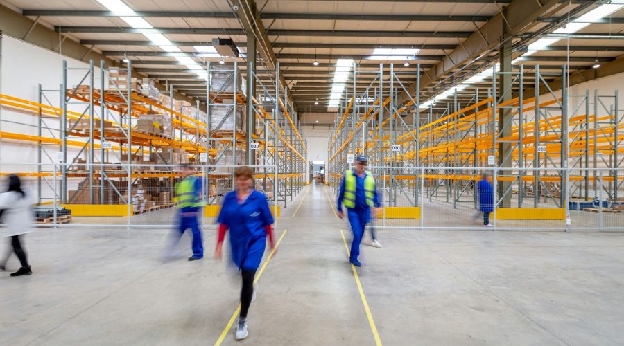 People walking through a warehouse.