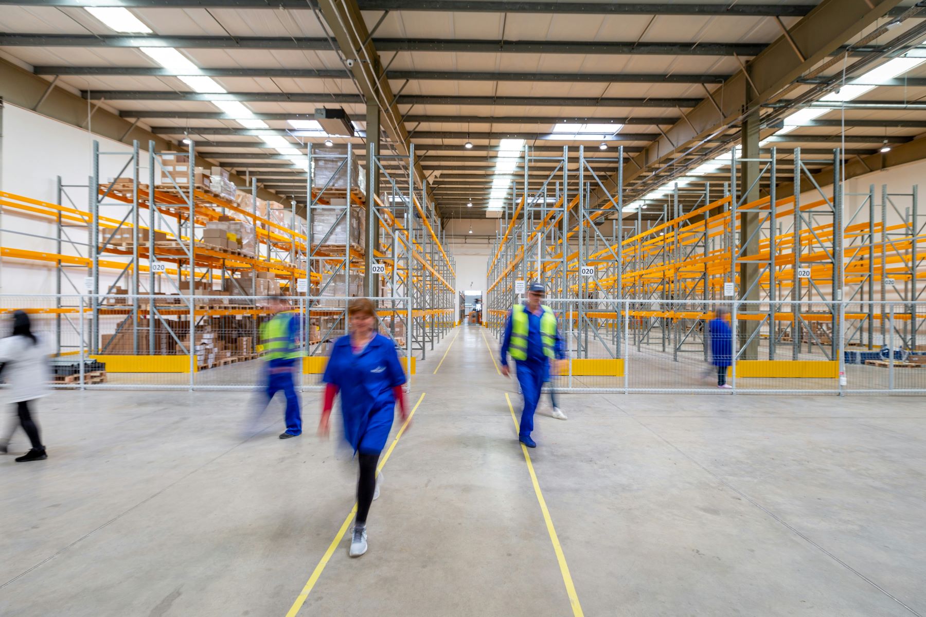 People walking through a warehouse.